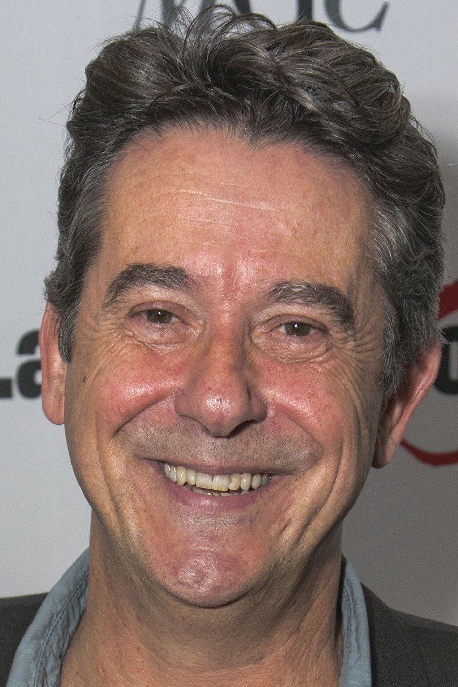 A headshot of Adrian Lukis.