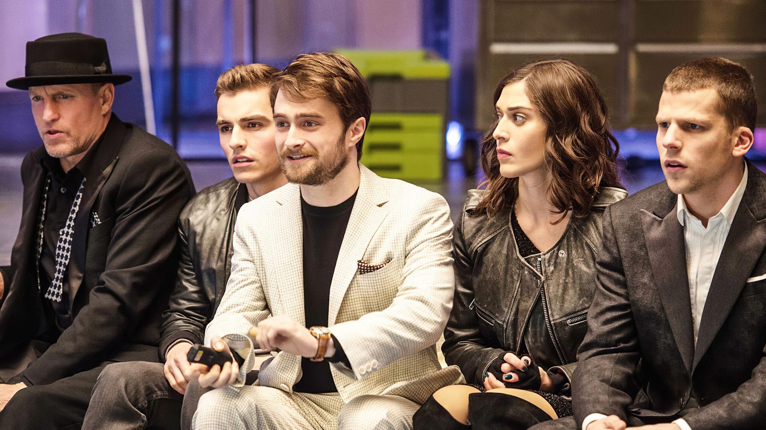 The Four Horsemen (Woody Harrelson, Dave Franco, Lizzy Caplan, Jesse Eisenberg) sitting with Daniel Radcliffe as Walter Mabry in Now You See Me 2.