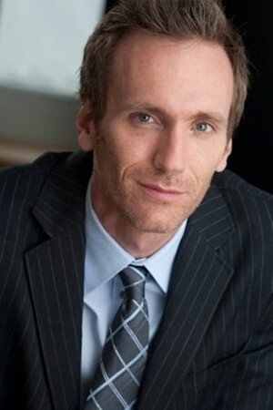 A headshot of Tom Carey.