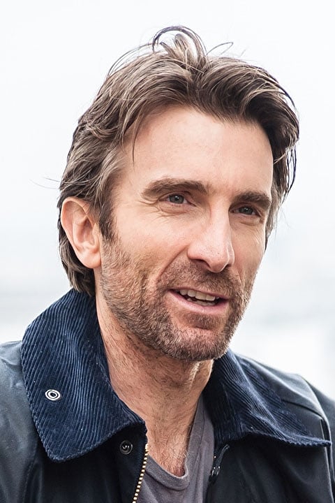 A headshot of Sharlto Copley.