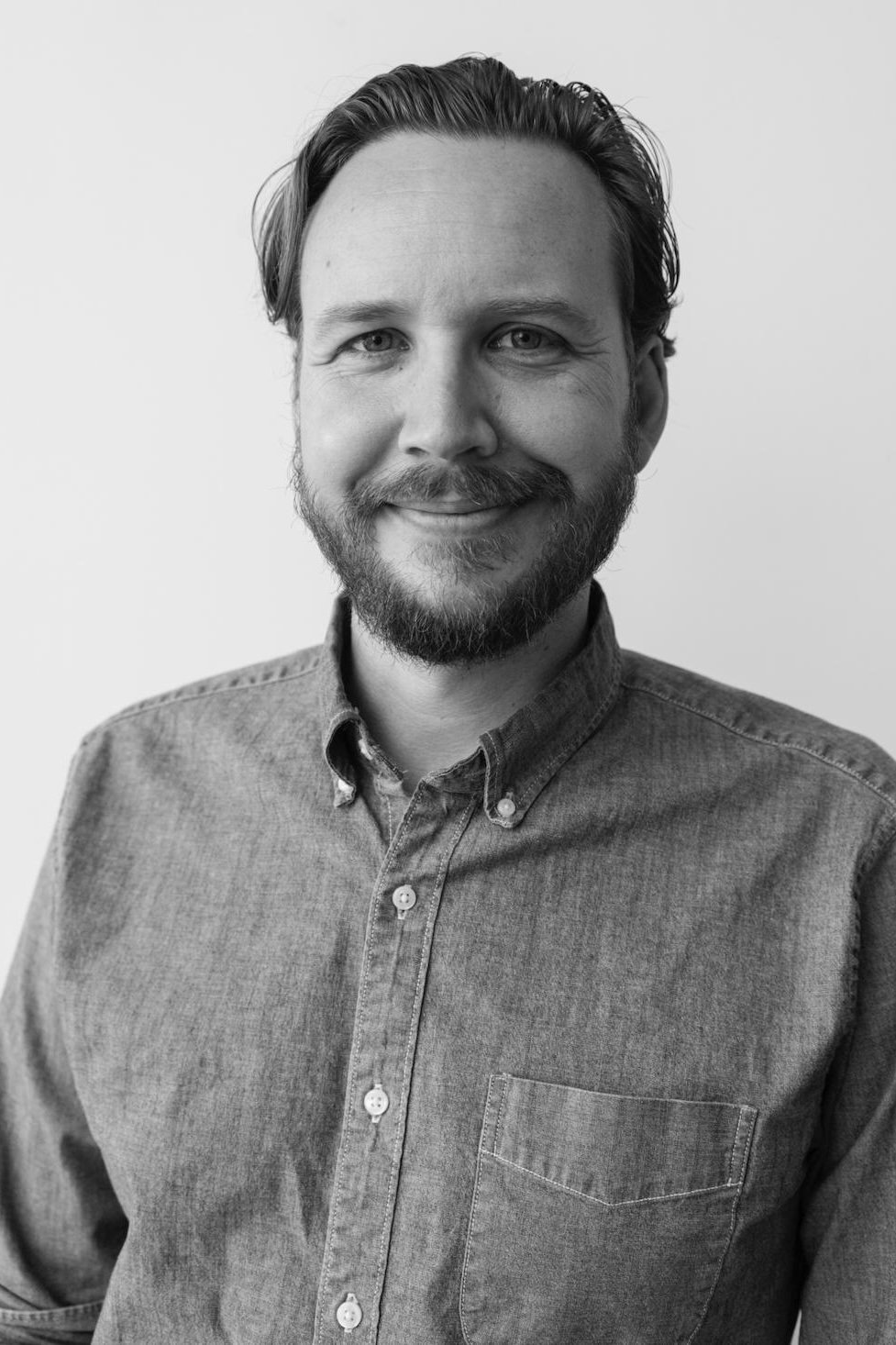 A headshot of Adam Hendricks.