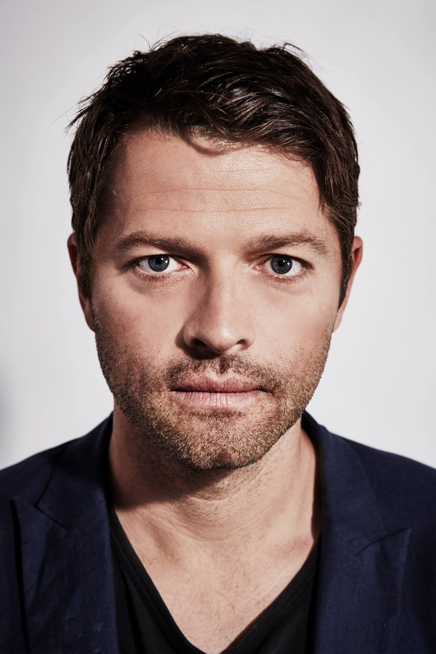 A headshot of Misha Collins.